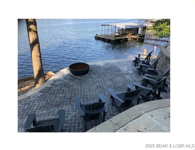 view of patio with a floating dock and a water view