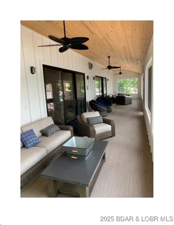 wooden terrace with outdoor lounge area and ceiling fan