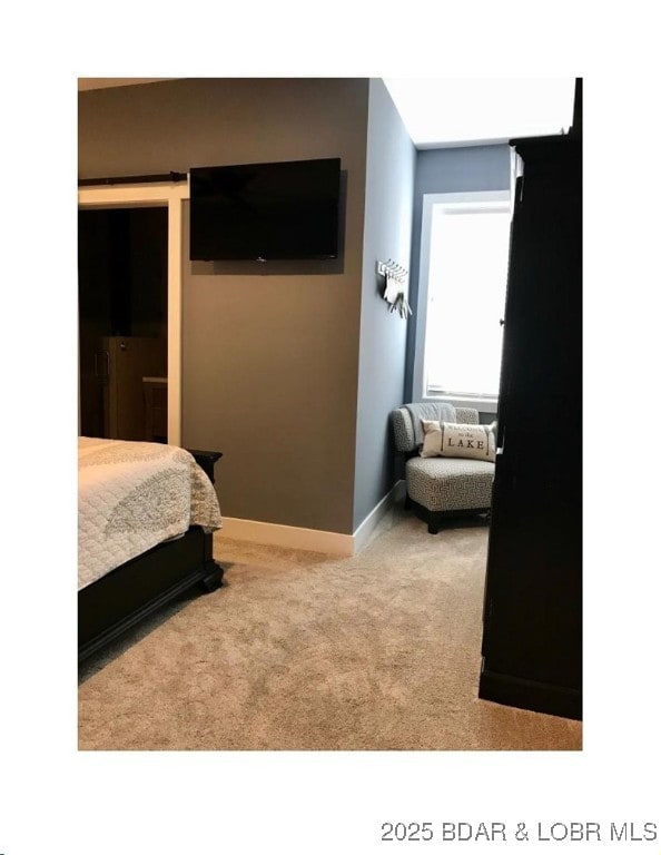 carpeted bedroom featuring baseboards