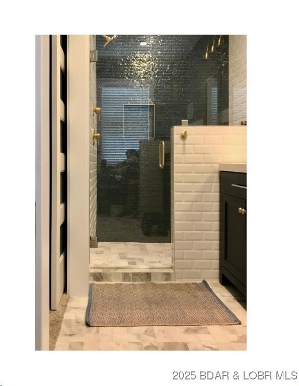 bathroom with vanity and a shower stall