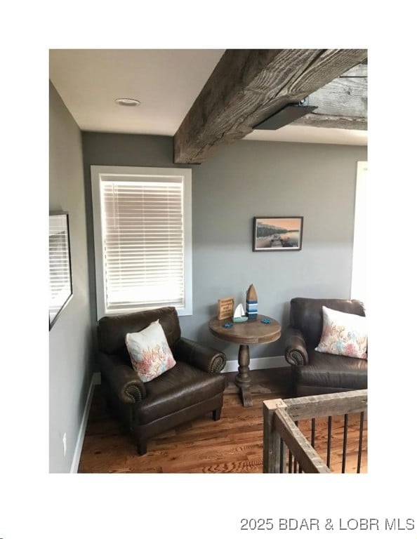 living room featuring baseboards and wood finished floors