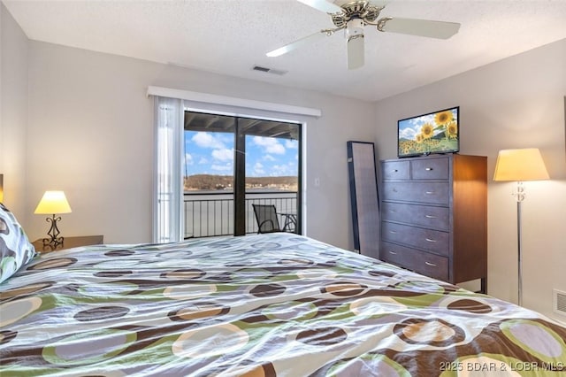 bedroom featuring visible vents, a textured ceiling, a ceiling fan, and access to outside