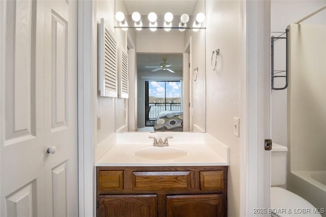 ensuite bathroom with vanity, toilet, ensuite bathroom, and ceiling fan