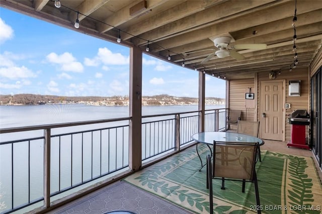 balcony featuring a water view, a grill, and ceiling fan