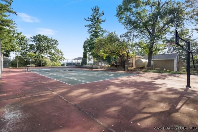 view of tennis court with fence