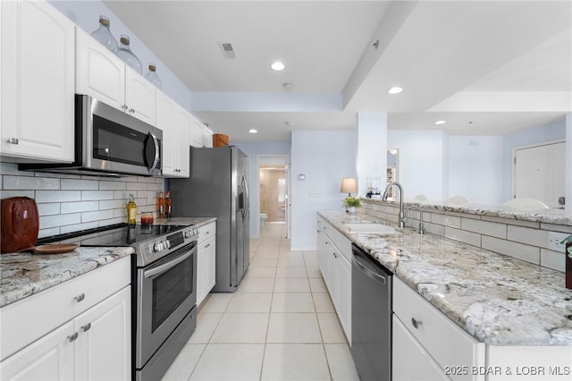 372 W Palisades Condo Dr Unit 4A, Lake Ozark, MO 65049 - kitchen with stainless steel appliances, a sink, tasteful backsplash, recessed lighting, and light stone counters