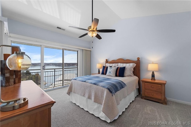 bedroom featuring baseboards, visible vents, access to exterior, a water view, and carpet flooring