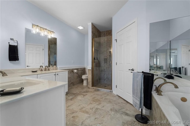 bathroom featuring tile walls, toilet, a garden tub, a stall shower, and vanity