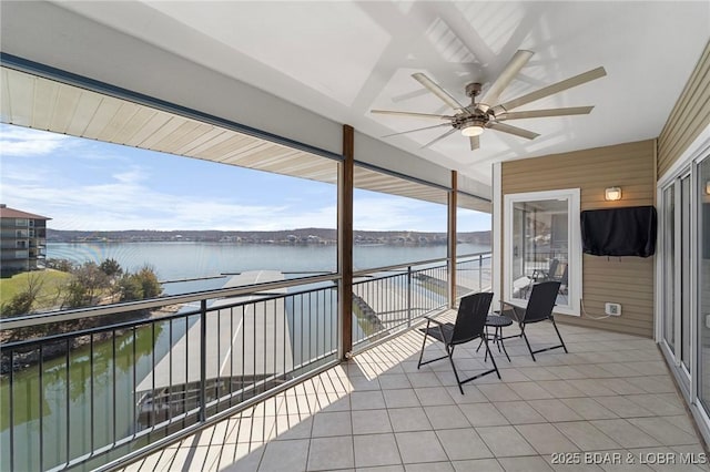 exterior space with a ceiling fan and a water view