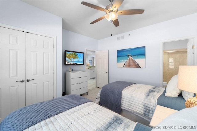 bedroom featuring visible vents, ensuite bath, ceiling fan, a closet, and light carpet