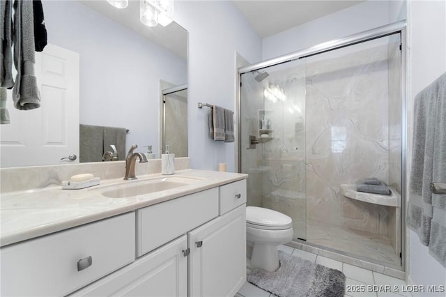 full bathroom with tile patterned floors, a marble finish shower, toilet, and vanity