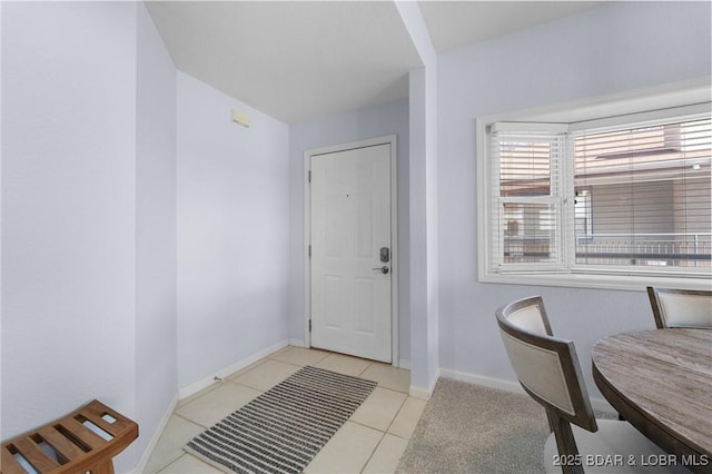 tiled entrance foyer with baseboards