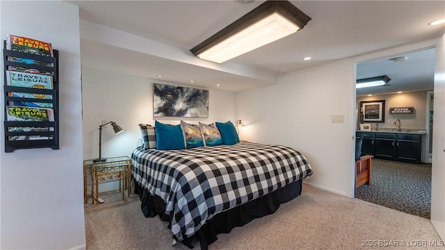 carpeted bedroom featuring recessed lighting, wet bar, and baseboards