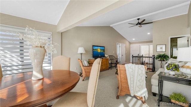 carpeted dining area with high vaulted ceiling and ceiling fan