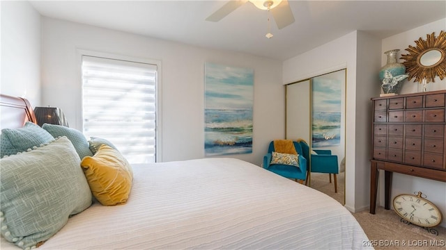 bedroom with a closet, multiple windows, a ceiling fan, and carpet flooring