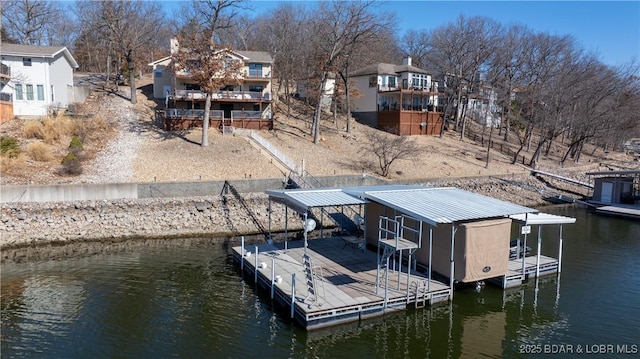 view of dock with a residential view and a water view