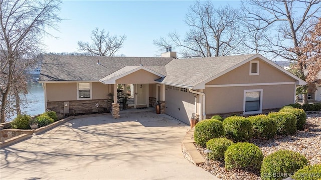 ranch-style home with stucco siding, a chimney, concrete driveway, and an attached garage