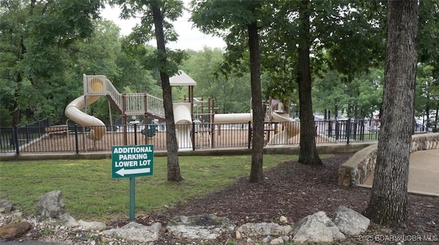 community playground featuring a lawn and fence