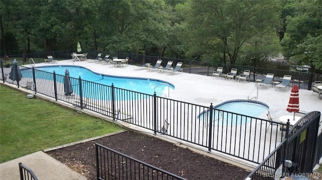 pool featuring a patio area and fence