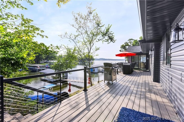 wooden terrace with a water view and a grill