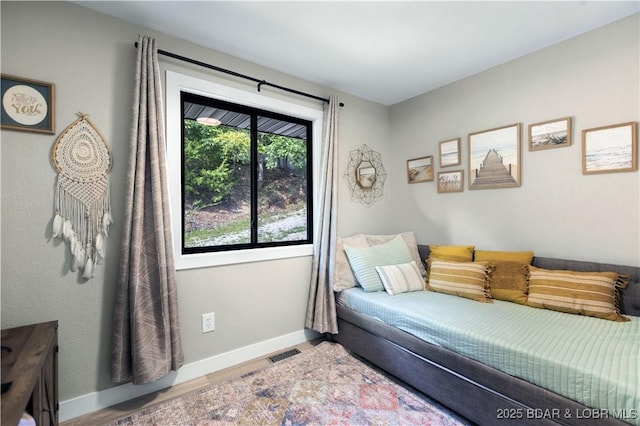 interior space with visible vents, baseboards, and wood finished floors