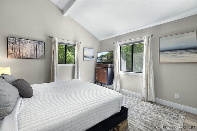 bedroom featuring lofted ceiling with beams, multiple windows, and baseboards