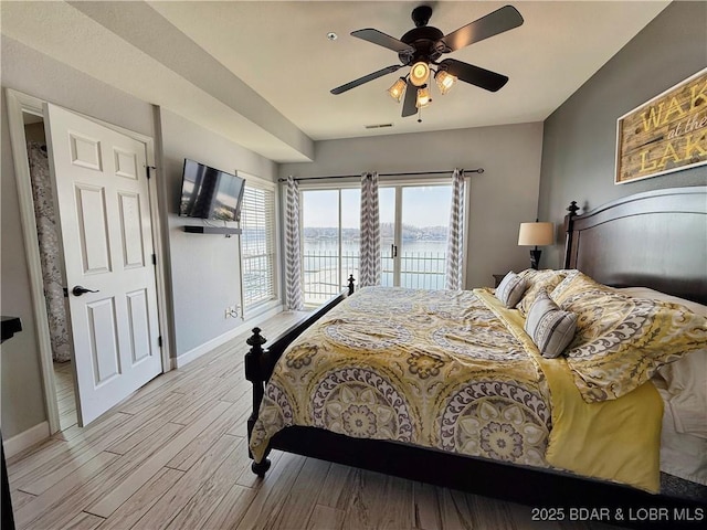 bedroom with access to exterior, baseboards, ceiling fan, and light wood finished floors