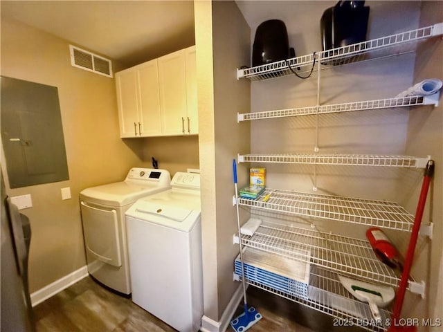 laundry area featuring visible vents, baseboards, electric panel, separate washer and dryer, and cabinet space