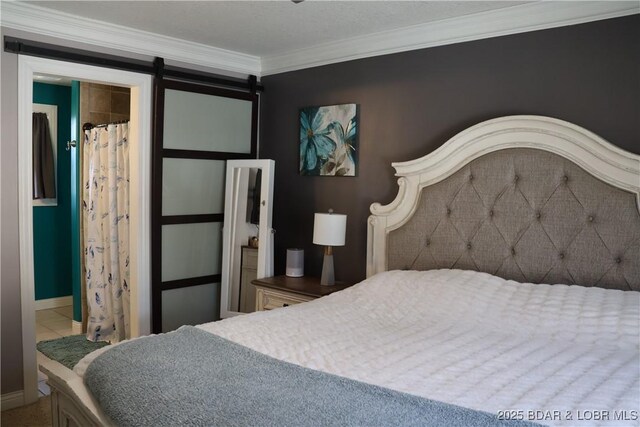 bedroom featuring a barn door and ornamental molding