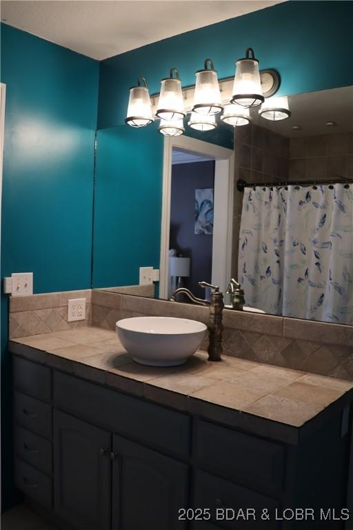 bathroom featuring curtained shower and vanity