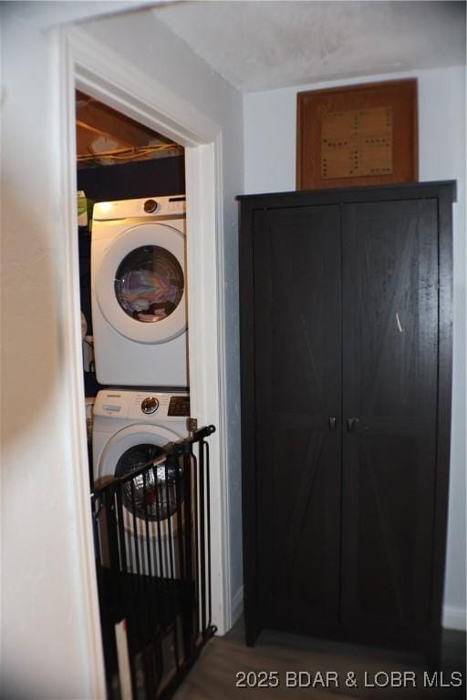 clothes washing area featuring laundry area and stacked washer / dryer