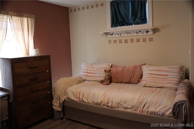 bedroom with wood finished floors