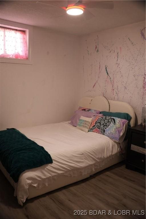 bedroom with wood finished floors and a ceiling fan