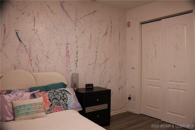 bedroom featuring a closet and dark wood-type flooring