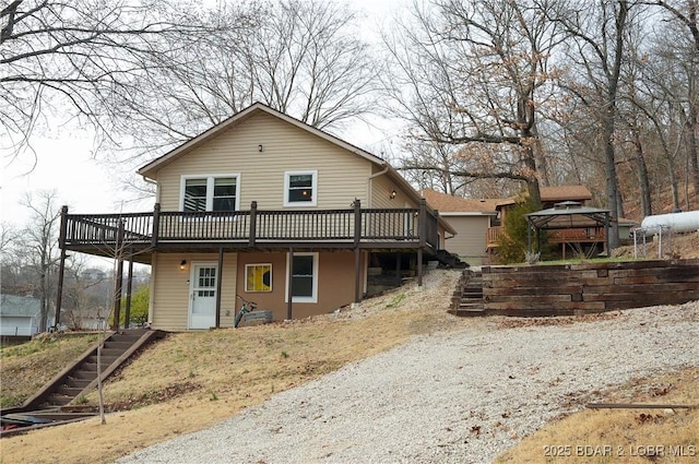 view of front of home featuring stairs and a deck