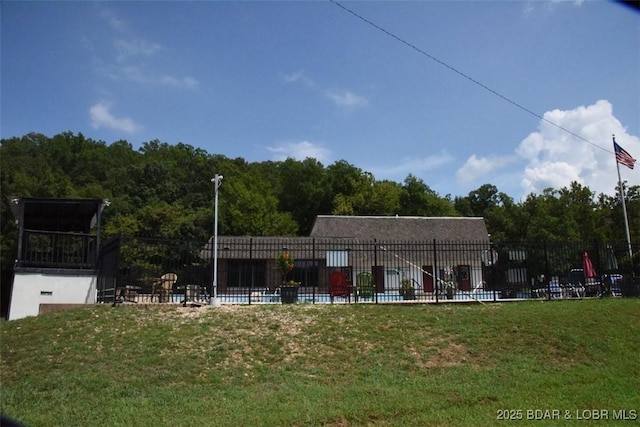 exterior space featuring fence and a forest view