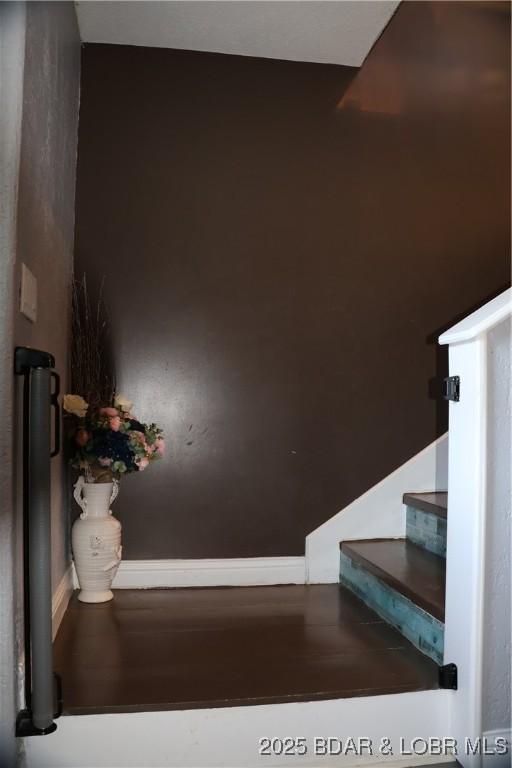 stairway featuring baseboards