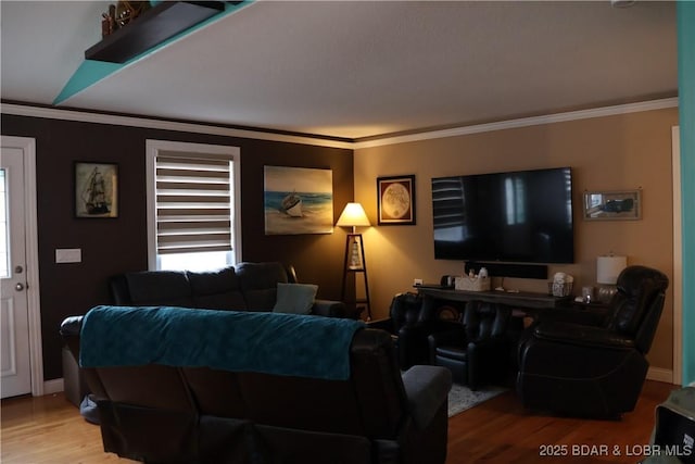 living room featuring crown molding, wood finished floors, and baseboards