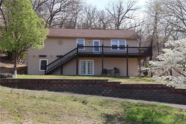 rear view of property featuring french doors, a yard, a deck, and stairs