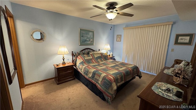 carpeted bedroom featuring a ceiling fan and baseboards