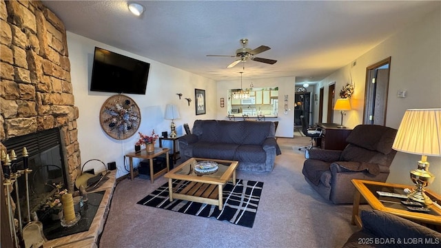 living room with a fireplace, light colored carpet, and ceiling fan