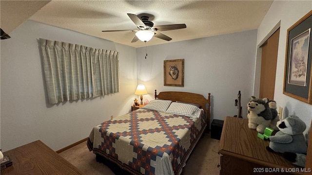 bedroom featuring baseboards, carpet, a closet, a textured ceiling, and a ceiling fan