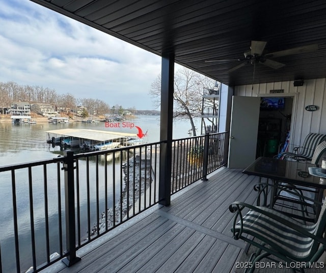 wooden terrace featuring a water view and a ceiling fan