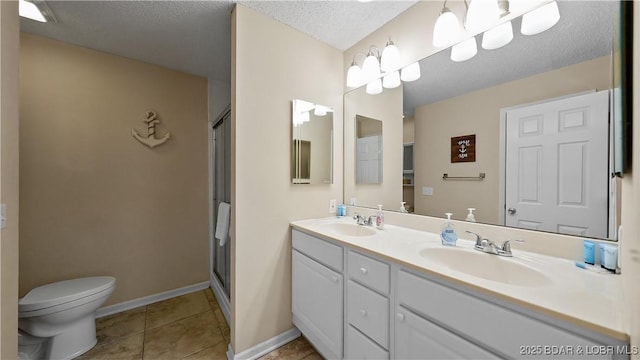 full bathroom with tile patterned flooring, a stall shower, a textured ceiling, and a sink