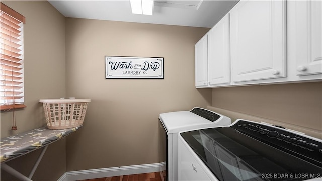 laundry room featuring cabinet space, separate washer and dryer, and baseboards