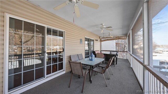 sunroom / solarium with a ceiling fan