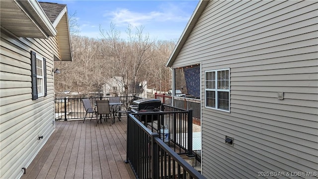 wooden deck featuring outdoor dining area