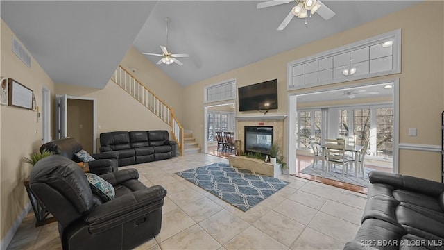 living area with tile patterned floors, plenty of natural light, and a ceiling fan