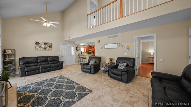 living room with light tile patterned floors, a ceiling fan, and visible vents