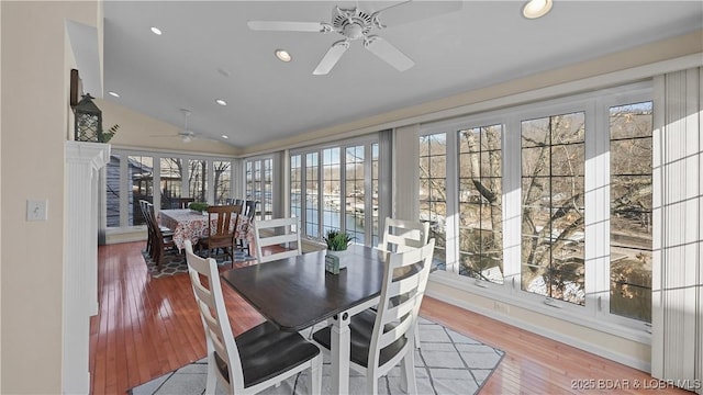 dining space featuring lofted ceiling, recessed lighting, wood-type flooring, and ceiling fan